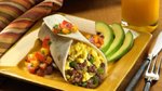 Indulge in a delectable breakfast burrito infused with savoury sausage,...
