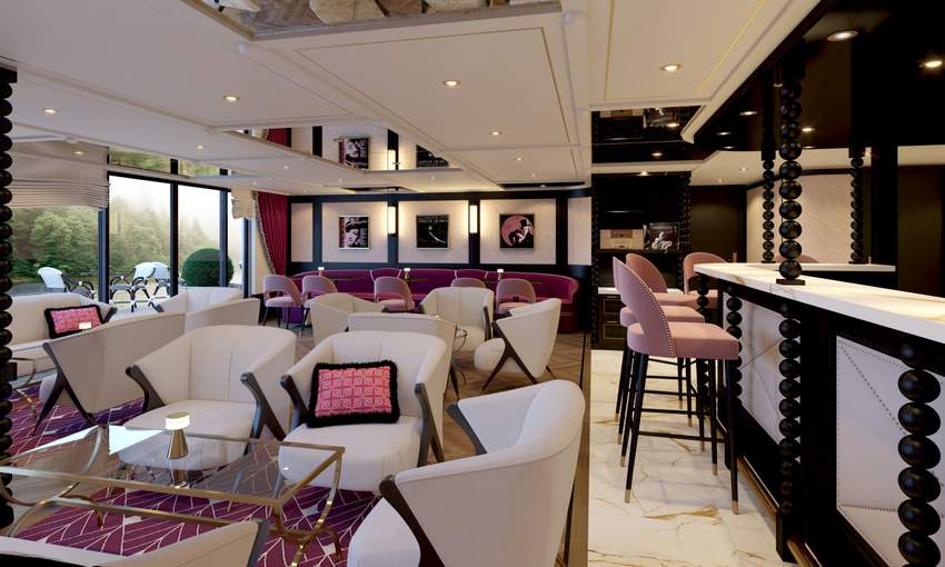 Elegant lounge interior with armchairs, bar seating and large windows overlooking greenery.