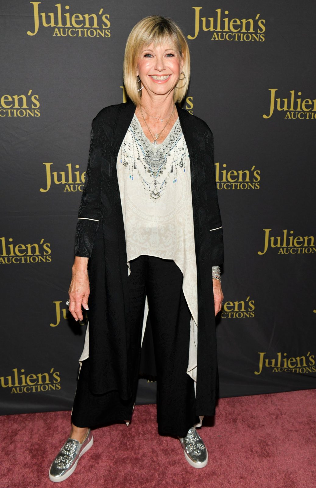 Olivia Newton-John opted for elegant comfort for the reception. Source: Getty.