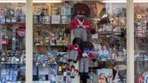 Jennifer makes and sells golliwog dolls, like the ones in this shop window, and says they are much loved children's toys. Source: Getty Images