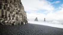 Reynisfjara beach with it's black volcanic sands, smooth pebbles, unique rock formations and overall moody atmosphere is located on the south coast of Iceland. Source: Getty Images