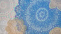 Close up of crocheted doilies hanging on a wall
