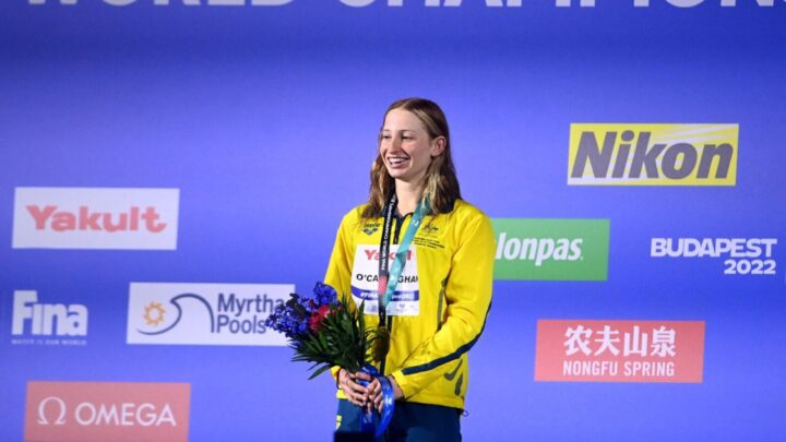 Australia's Mollie O'Callaghan celebrates on the podium after winning the women's 100m freestyle final. Source: Twitter @HerwayMagazine