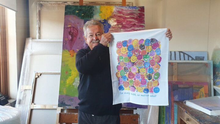 Ken Done with one of his UNICEF exclusive tea towels. Image source: Provided by UNICEF Australia