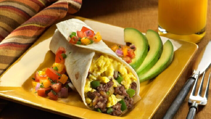 Indulge in a delectable breakfast burrito infused with savoury sausage, fluffy eggs, and avocado - S