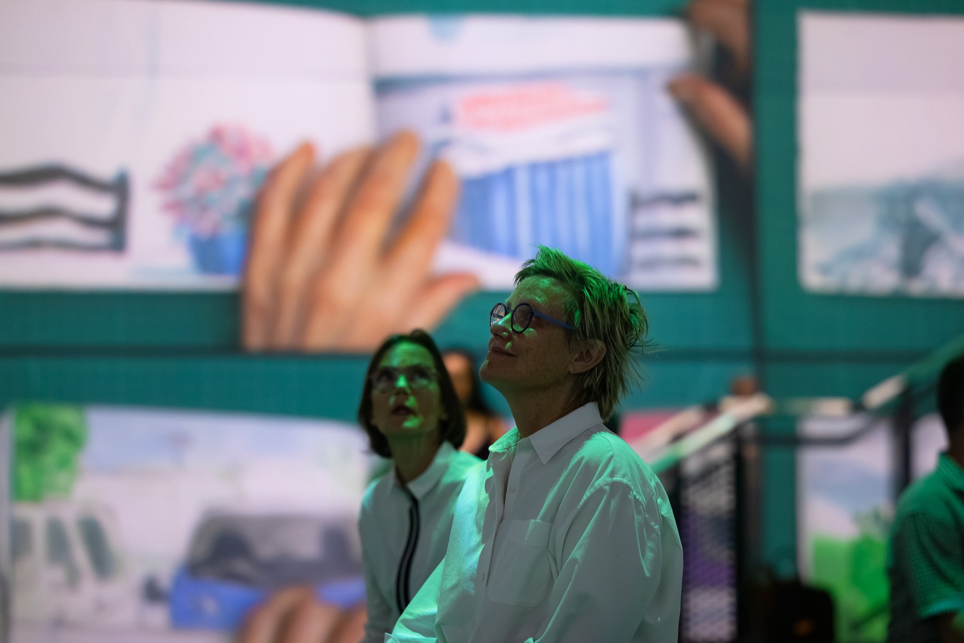 Two women stare on in amazement at David Hockney: Bigger & Closer (Not smaller and further away), showing at Carriageworks, Sydney, from 22 October 2026 to 24 January 2027.